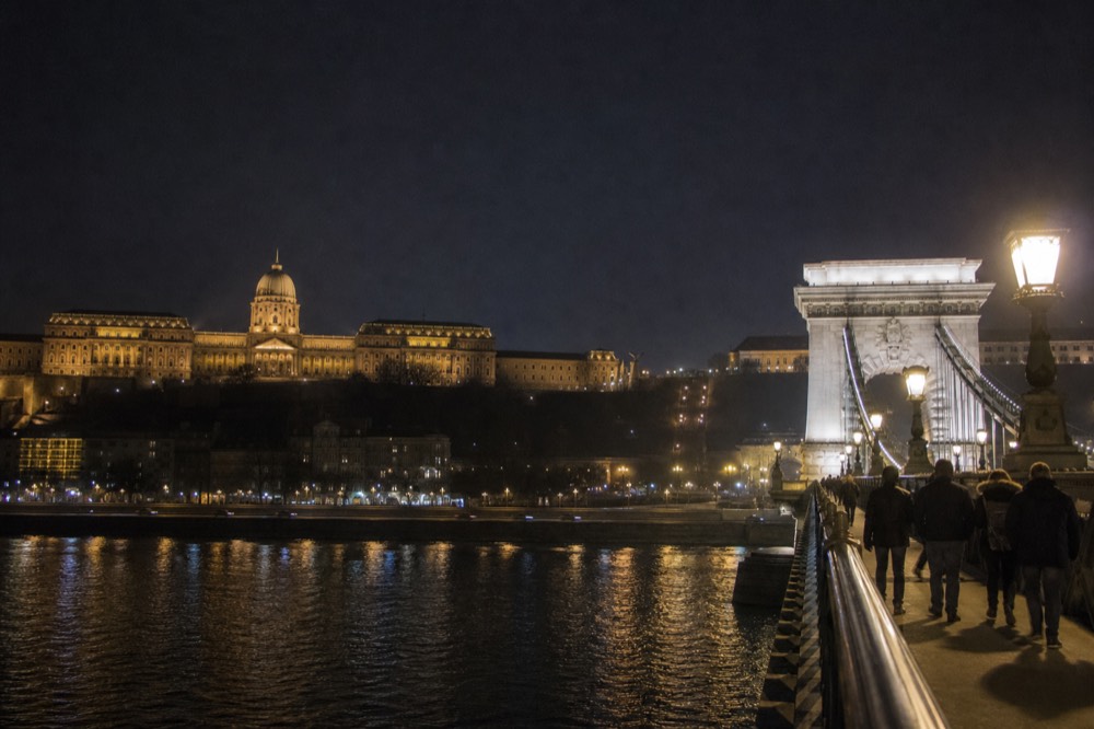 Buda Castle and the Chain Bridge lit up over the Danube after dark, no text, no logos, no people
