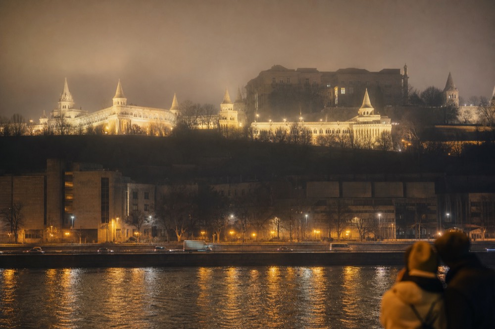 Fisherman's Bastion illuminated at night seen from the Danube, no text, no logos, no people