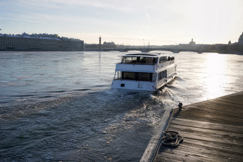 A cruise boat departing from the Danube embankment in daytime, no text, no logos, no people