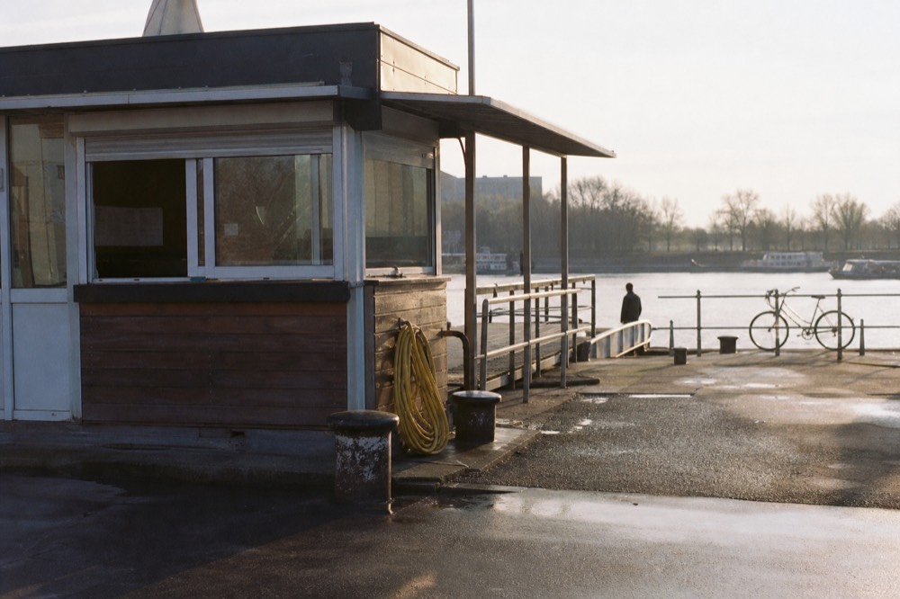 A ticket booth and dock entrance on the Danube embankment in Budapest, no text, no logos, no people