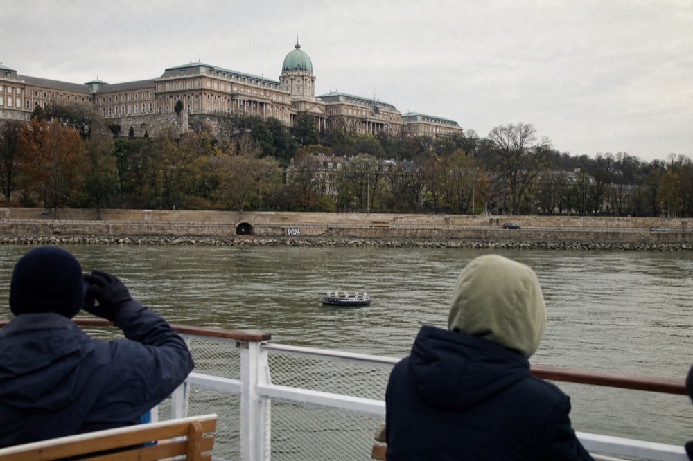 Short sightseeing boat on the Danube with Buda Castle in the background, daytime, no text, no logos, no people