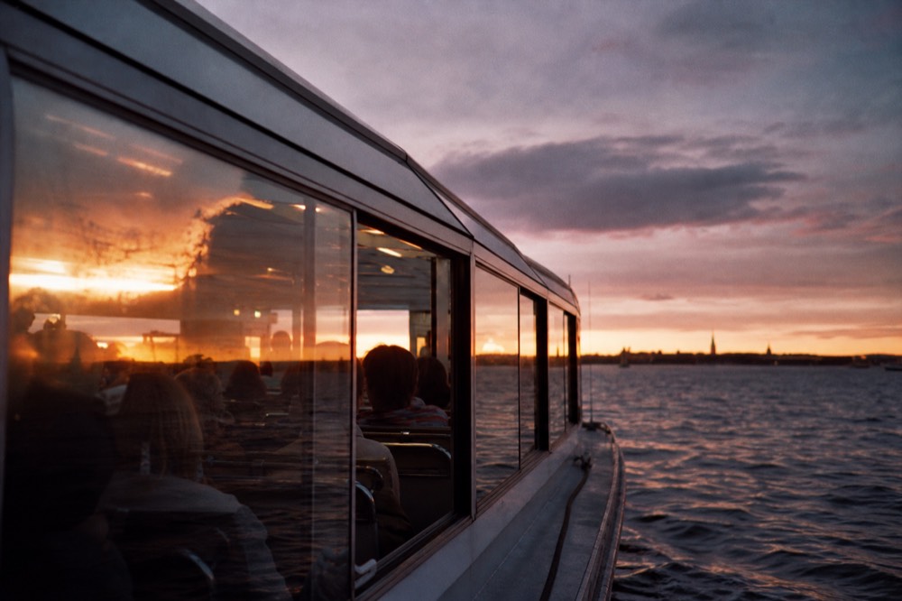 Glass-enclosed Legenda cruise boat on the Danube at sunset, no text, no logos, no people
